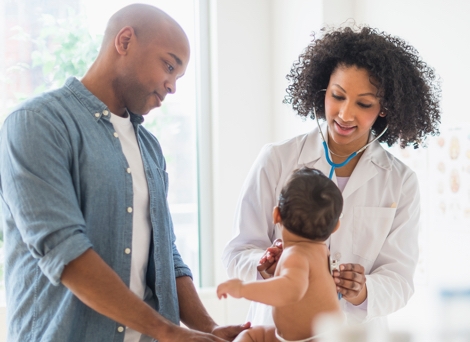 Doctor with parent and baby