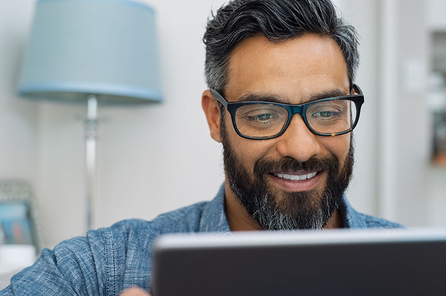 man with glasses using laptop picture